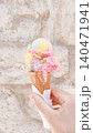 Tourist hand holding melting ice cream cone in croatia during summer vacation 140471941