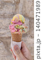 Tourist holding melting ice cream cone in croatia during summer vacation 140471989