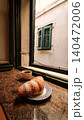 Enjoying a delicious breakfast with coffee and croissant by the window in croatia 140472006