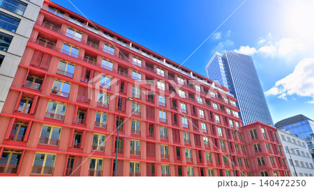 View of an modern apartment building standing next to a new modern office building with a glass facade. View of an modern apartment building standing next to a new modern office building with a glass facade. 140472250