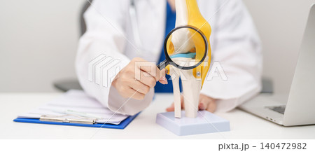 Doctor with Human Knee joint anatomy model. Osteoarthritis, Patellofemoral Pain Syndrome, Patellar Tendinitis, ACL, Anterior Cruciate Ligament, PCL, Posterior, MCL, Medial Collateral, LCL and Lateral 140472982