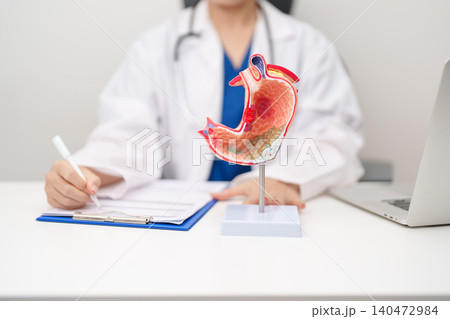 Doctor with Gastric anatomy model. Gastroenterologist consultation, stomach diseases and ulcers, November stomach cancer, Gastroesophageal Reflux Disease, GERD, Acid reflux and healthcare medical Doctor with Gastric anatomy model. Gastroenterologist consultation, stomach diseases and ulcers, November stomach cancer, Gastroesophageal Reflux Disease, GERD, Acid reflux and healthcare medical 140472984
