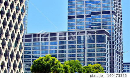 Exterior view of corporate headquarters glass buildings architecture. Modern sustainable glass office buildings. Glass windows in energy-efficient buildings. Financial business center buildings. Exterior view of corporate headquarters glass buildings architecture. Modern sustainable glass office buildings. Glass windows in energy-efficient buildings. Financial business center buildings. 140473336