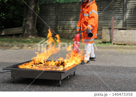 fire prevention. corporate safety - exercise during a firefighting course 140473358
