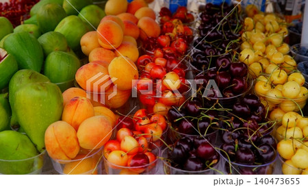 Colorful fresh fruit display at farmers market with apples cherries Colorful fresh fruit display at farmers market with apples cherries 140473655