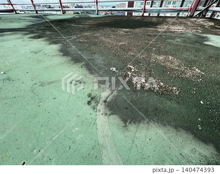 Old flat roof blisters due to moisture between layers of the roofing material. 140474393