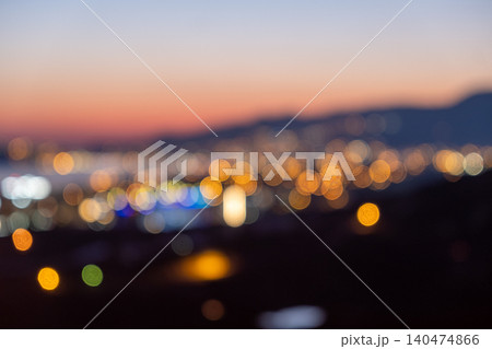 The twilight sky is filled with soft colors as city lights create a glowing backdrop, showcasing the lively atmosphere of urban life during evening hours. The twilight sky is filled with soft colors as city lights create a glowing backdrop, showcasing the lively atmosphere of urban life during evening hours. 140474866