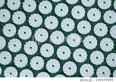 Macro abstract background of green acupuncture massage mat needles. Macro abstract background of green acupuncture massage mat needles. 140474994