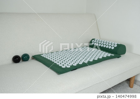 Green acupuncture applicator mat for body relaxation and alternative medicine Green acupuncture applicator mat for body relaxation and alternative medicine 140474998