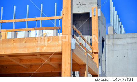 Laminate wood floors and supports of a mass timber multi story green, sustainable office building construction project. The building structure also has concrete walls. 140475831