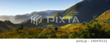 Mountain, fog and natural hill with field, blue sky and calm landscape for travel location. Nature, green and sustainable environment with earth, peace and holiday destination with conservation Mountain, fog and natural hill with field, blue sky and calm landscape for travel location. Nature, green and sustainable environment with earth, peace and holiday destination with conservation 140476152