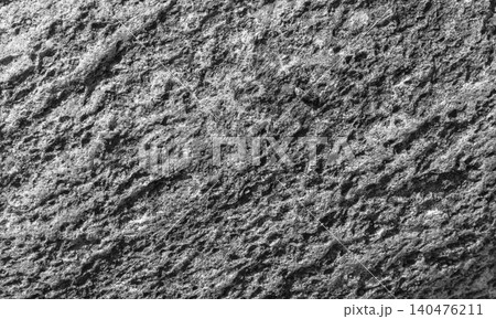 Close-up of a rugged rock surface showing granular texture. Black and white Close-up of a rugged rock surface showing granular texture. Black and white 140476211