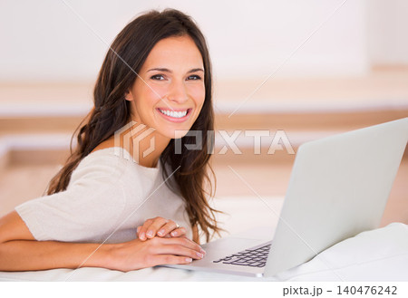 Woman, laptop and smile on sofa with remote work from home in portrait, living room and freelance editing. Person, writer and happy with pc on couch for typing, creativity and article in Barcelona 140476242