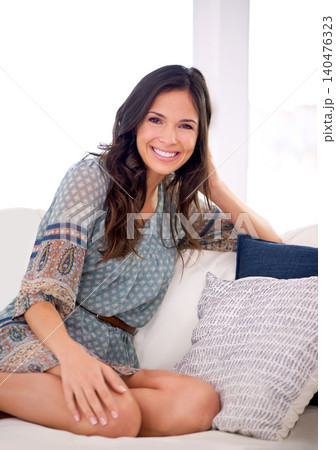 Woman, relax and smile on couch for portrait in home for vacation, pride and confident in living room. Person, happy and sitting on sofa with fashion, style and lounge at apartment in Barcelona Woman, relax and smile on couch for portrait in home for vacation, pride and confident in living room. Person, happy and sitting on sofa with fashion, style and lounge at apartment in Barcelona 140476323