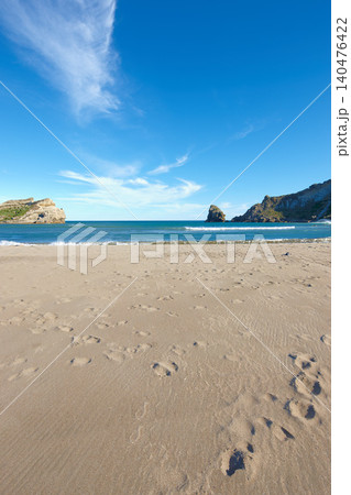 Beach sand, blue sky and ocean, landscape with nature and environment, coastline and travel destination. Horizon, waves and seascape with natural background, tropical location or island for holiday 140476422