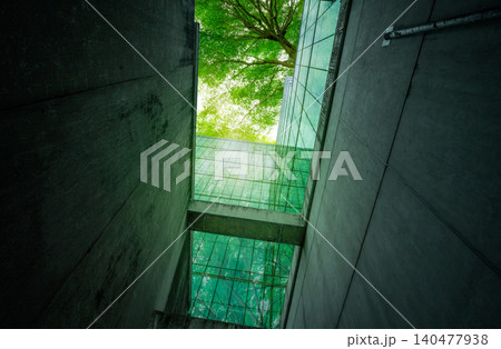 Eco-friendly building in modern city. Sustainable glass office building with trees for reducing carbon dioxide. Office building with green environment. Corporate building reduce CO2. Net zero emission 140477938