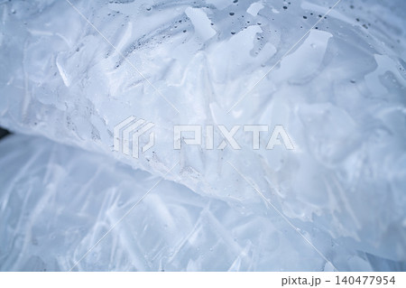 Closeup of tube ice inside a clear plastic bag. Convenient and lightweight packaging designed for easy transportation and storage. Hygiene and freshness for commercial and industrial applications. Closeup of tube ice inside a clear plastic bag. Convenient and lightweight packaging designed for easy transportation and storage. Hygiene and freshness for commercial and industrial applications. 140477954