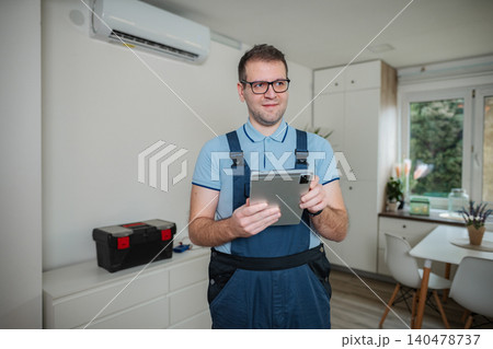 Worker checking air conditioning system at home 140478737