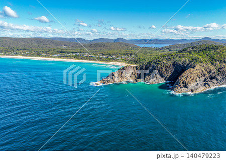 Aerial scene capturing the rocky headland of Charlotte Head and Boomerang Beach near Pacific Palms, NSW, Australia. Surrounded by clear turquoise waters, rugged coastal formations Aerial scene capturing the rocky headland of Charlotte Head and Boomerang Beach near Pacific Palms, NSW, Australia. Surrounded by clear turquoise waters, rugged coastal formations 140479223