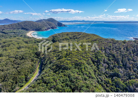 Aerial scene capturing Elizabeth Beach near Pacific Palms, NSW, Australia, with the surrounding bushland landscape and Wallis Lake visible in the distance. Aerial scene capturing Elizabeth Beach near Pacific Palms, NSW, Australia, with the surrounding bushland landscape and Wallis Lake visible in the distance. 140479308