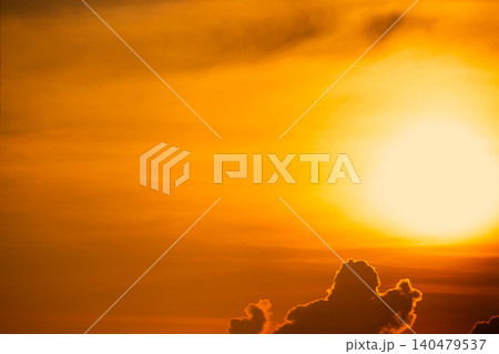Beautiful golden sunset sky. Dramatic yellow and orange sky at sunset time. Peaceful and tranquil scene. Golden sunset sky with a majestic sun. Golden sunset sky with a big sun. Scenic Landscape. 140479537