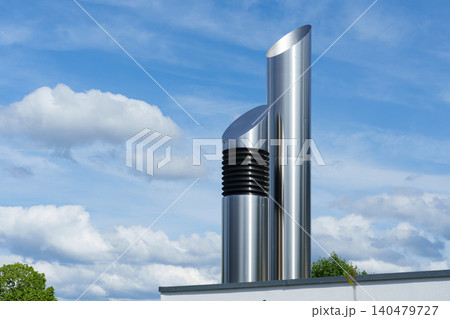 Minimalist metal chimney against blue sky Minimalist metal chimney against blue sky 140479727