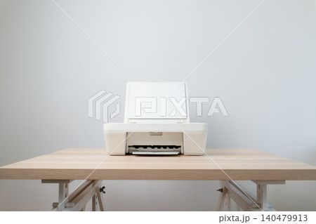 White Inkjet Printer On Wooden Desk In Minimal Home Office With Open Scanner Setup White Inkjet Printer On Wooden Desk In Minimal Home Office With Open Scanner Setup 140479913