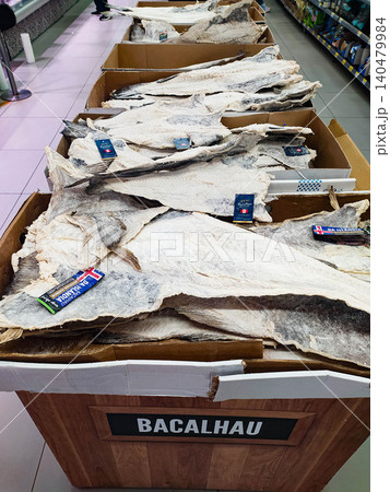 Authentic salted cod fish, or bacalhau, beautifully displayed in a market setting. This traditional preserved seafood represents rich culinary heritage and artisanal food culture. Authentic salted cod fish, or bacalhau, beautifully displayed in a market setting. This traditional preserved seafood represents rich culinary heritage and artisanal food culture. 140479984