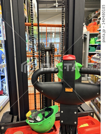 a freight elevator and a safety helmet in a hardware store a freight elevator and a safety helmet in a hardware store 140480185