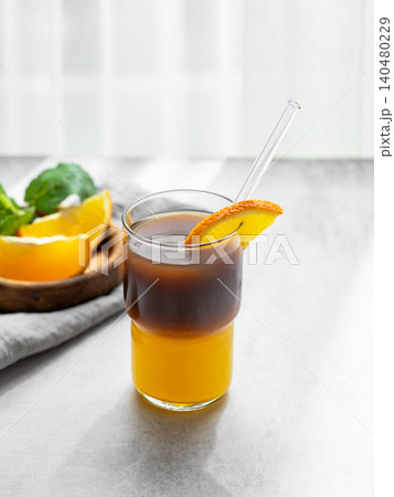 Cold bumble coffee with orange juice and ice on light background 140480229