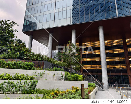 Ground level plaza with columned entrance, inviting steps and greenery frame office lobby. Ground level plaza with columned entrance, inviting steps and greenery frame office lobby. 140480662