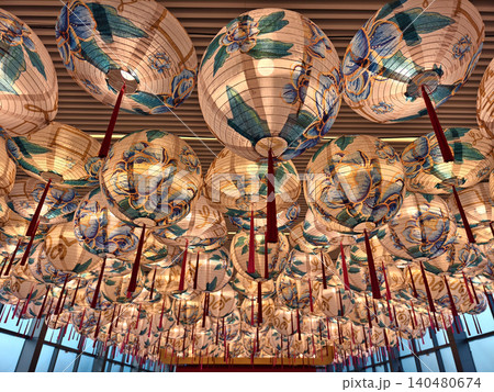 Gold lanterns fill ornate temple ceiling, warm glow casting patterned shadows, red tassels swinging Gold lanterns fill ornate temple ceiling, warm glow casting patterned shadows, red tassels swinging 140480674