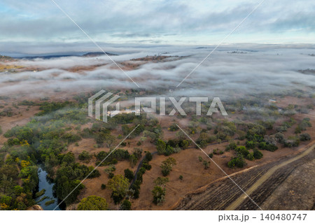 Vertical Aerial image of the scenic landscape alongside Glenbawn Dam with fog rolling through the valley in NSW Australia. Drone photograph captures rugged mountain scenery, atmospheric low cloud Vertical Aerial image of the scenic landscape alongside Glenbawn Dam with fog rolling through the valley in NSW Australia. Drone photograph captures rugged mountain scenery, atmospheric low cloud 140480747