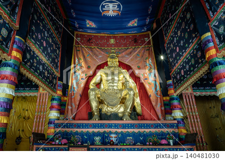 majestic, muscular golden deity sits enthroned beneath an ornate canopy, surrounded by richly detailed, multicolored tapestries and traditional embroidered banners that evoke a profound sense of majestic, muscular golden deity sits enthroned beneath an ornate canopy, surrounded by richly detailed, multicolored tapestries and traditional embroidered banners that evoke a profound sense of 140481030