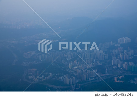 Looking from the airplane window with Hong Kong cityscape. The view of Hong Kong city, Hong Kong landscape from the above. Landscape, travel concept and nature scene. Looking from the airplane window with Hong Kong cityscape. The view of Hong Kong city, Hong Kong landscape from the above. Landscape, travel concept and nature scene. 140482245
