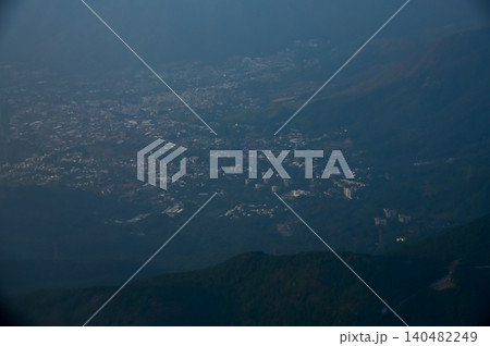 Looking from the airplane window with Hong Kong cityscape. The view of Hong Kong city, Hong Kong landscape from the above. Landscape, travel concept and nature scene. Looking from the airplane window with Hong Kong cityscape. The view of Hong Kong city, Hong Kong landscape from the above. Landscape, travel concept and nature scene. 140482249