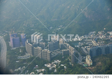 Looking from the airplane window with Hong Kong cityscape. The view of Hong Kong city, Hong Kong landscape from the above. Landscape, travel concept and nature scene.  140482265
