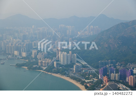 Looking from the airplane window with Hong Kong cityscape. The view of Hong Kong city, Hong Kong landscape from the above. Landscape, travel concept and nature scene.  140482272