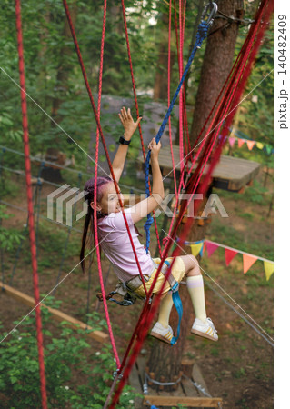 The child fell off the rope track, hanging on a safety rope. Active Sports Recreation Park 140482409