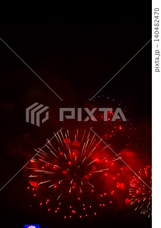 Stunning and colorful fireworks display in the night sky. Real fireworks background. Abstract of real shining fireworks against black background. Glowing fireworks show for celebration. Stunning and colorful fireworks display in the night sky. Real fireworks background. Abstract of real shining fireworks against black background. Glowing fireworks show for celebration. 140482470