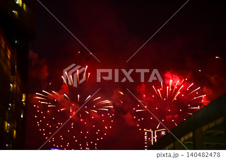 Stunning and colorful fireworks display in the night sky. Real fireworks background. Abstract of real shining fireworks against black background. Glowing fireworks show for celebration. Stunning and colorful fireworks display in the night sky. Real fireworks background. Abstract of real shining fireworks against black background. Glowing fireworks show for celebration. 140482478