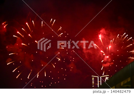 Stunning and colorful fireworks display in the night sky. Real fireworks background. Abstract of real shining fireworks against black background. Glowing fireworks show for celebration. Stunning and colorful fireworks display in the night sky. Real fireworks background. Abstract of real shining fireworks against black background. Glowing fireworks show for celebration. 140482479