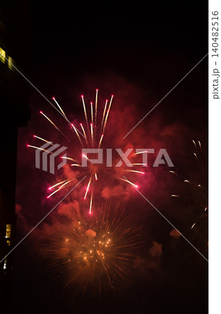 Stunning and colorful fireworks display in the night sky. Real fireworks background. Abstract of real shining fireworks against black background. Glowing fireworks show for celebration. Stunning and colorful fireworks display in the night sky. Real fireworks background. Abstract of real shining fireworks against black background. Glowing fireworks show for celebration. 140482516
