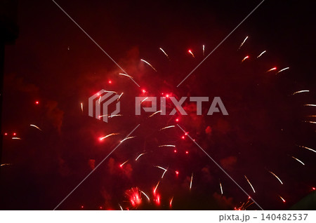 Stunning and colorful fireworks display in the night sky. Real fireworks background. Abstract of real shining fireworks against black background. Glowing fireworks show for celebration. Stunning and colorful fireworks display in the night sky. Real fireworks background. Abstract of real shining fireworks against black background. Glowing fireworks show for celebration. 140482537