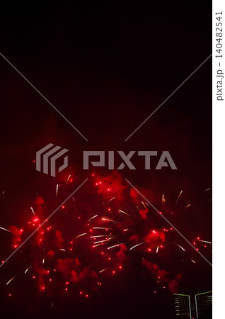 Stunning and colorful fireworks display in the night sky. Real fireworks background. Abstract of real shining fireworks against black background. Glowing fireworks show for celebration. Stunning and colorful fireworks display in the night sky. Real fireworks background. Abstract of real shining fireworks against black background. Glowing fireworks show for celebration. 140482541