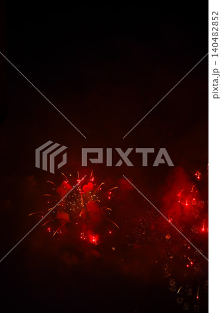 Stunning and colorful fireworks display in the night sky. Real fireworks background. Abstract of real shining fireworks against black background. Glowing fireworks show for celebration. Stunning and colorful fireworks display in the night sky. Real fireworks background. Abstract of real shining fireworks against black background. Glowing fireworks show for celebration. 140482852
