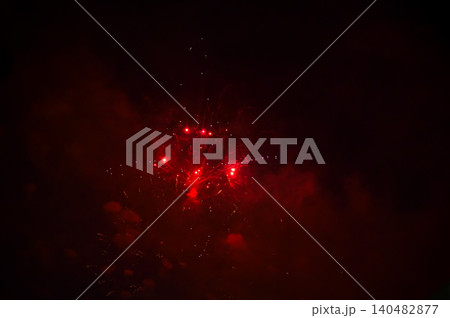 Stunning and colorful fireworks display in the night sky. Real fireworks background. Abstract of real shining fireworks against black background. Glowing fireworks show for celebration. Stunning and colorful fireworks display in the night sky. Real fireworks background. Abstract of real shining fireworks against black background. Glowing fireworks show for celebration. 140482877