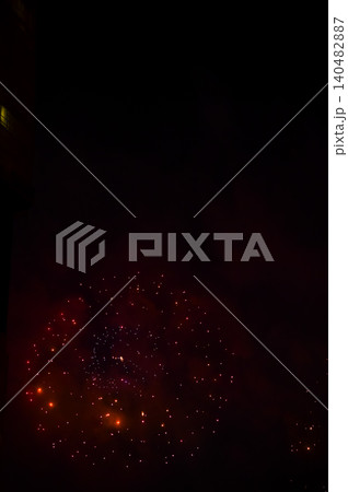 Stunning and colorful fireworks display in the night sky. Real fireworks background. Abstract of real shining fireworks against black background. Glowing fireworks show for celebration. Stunning and colorful fireworks display in the night sky. Real fireworks background. Abstract of real shining fireworks against black background. Glowing fireworks show for celebration. 140482887