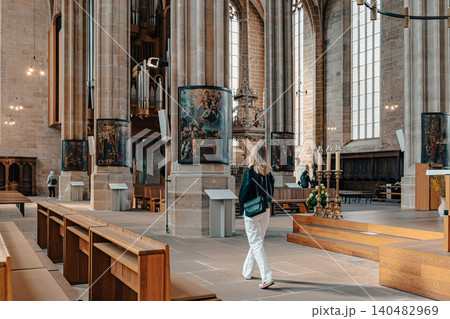 Erfurt, Germany - March 27, 2026. Visitor Inside Historic Gothic Church Erfurt, Germany - March 27, 2026. Visitor Inside Historic Gothic Church 140482969