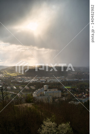 Vertical View of Sun Rays and Rain Over Valley 140482982
